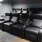 a theater room with black chairs