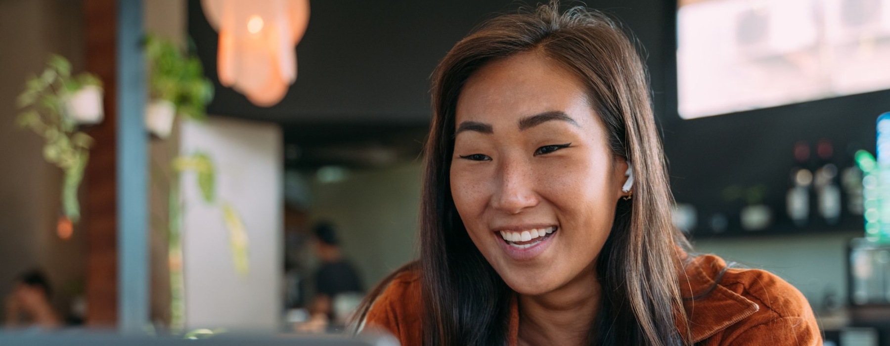 woman smiling and working on laptop